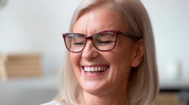 Lady wearing eyeglases and smiling